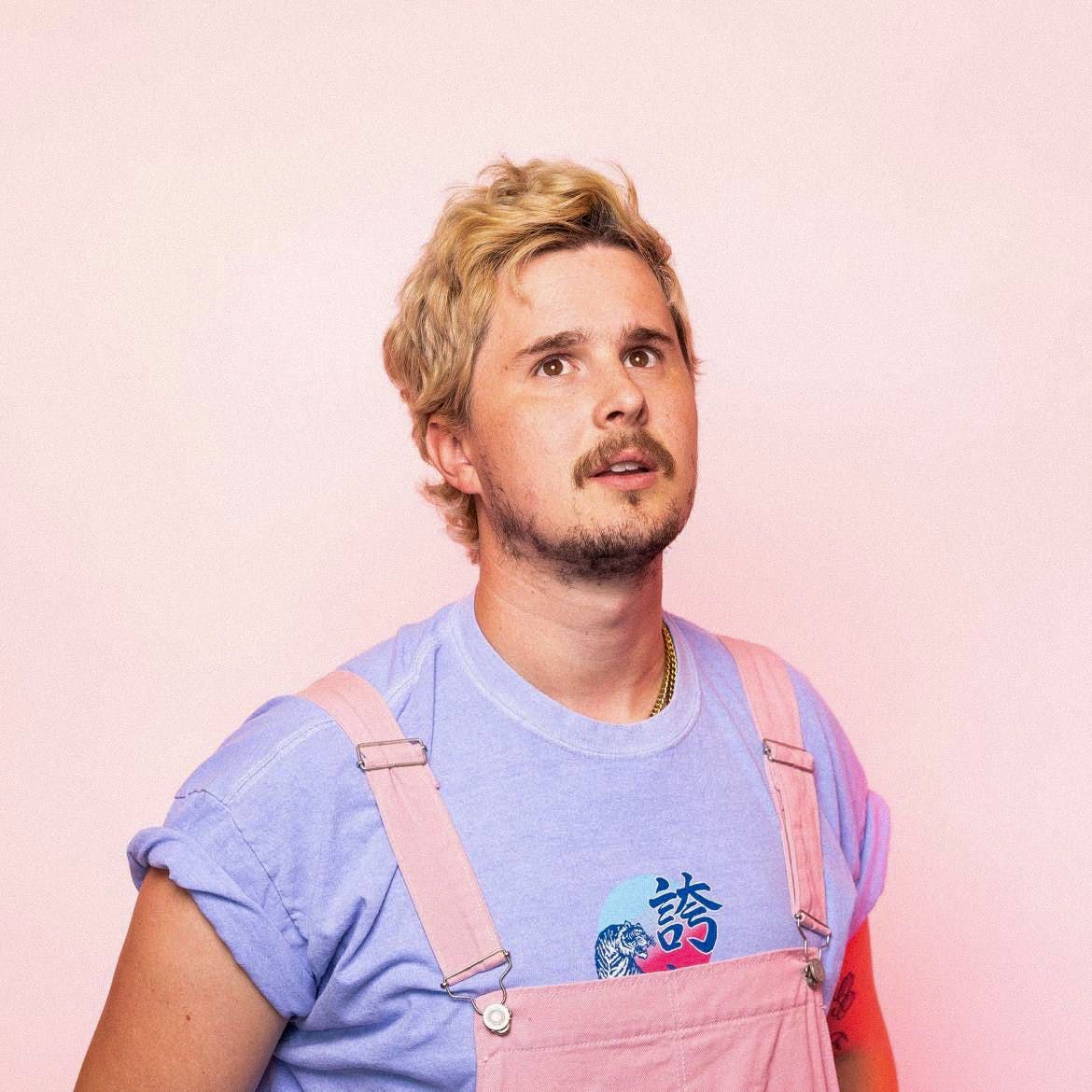 Lowly Labs team member Seth Dunshee, posing in pink overalls.